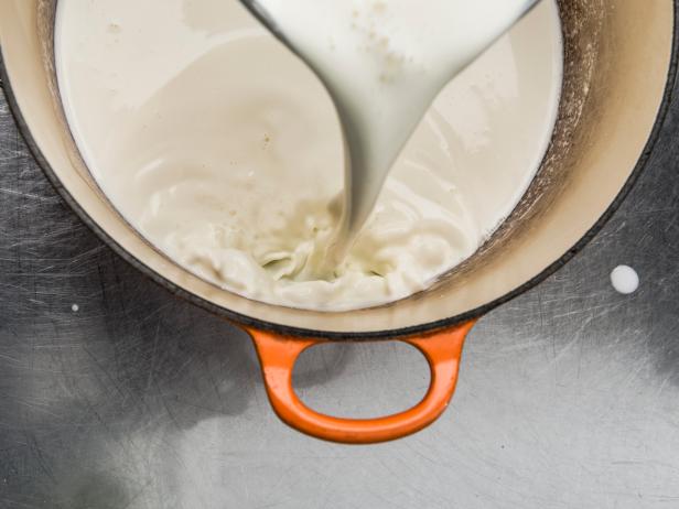 Milk pouring into pot