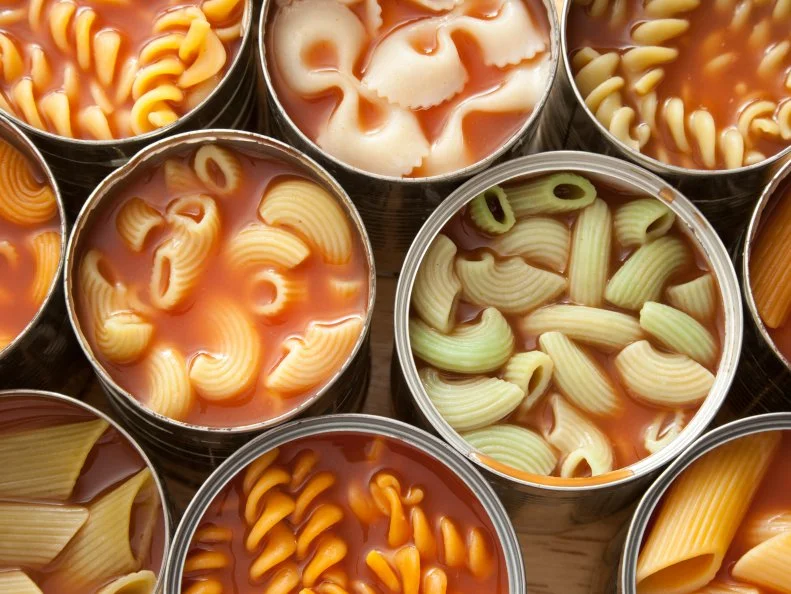 High angle view of lots of cans with variety of pastas in them