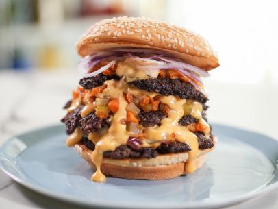 Alex Guarnaschelli makes her Triple Decker Burger with Roasted Vegetables and Cheese Sauce, as seen on The Kitchen, season 28.