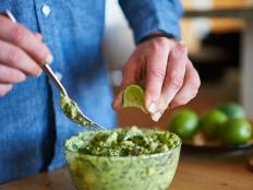 adding lime juice to guacamole shot with selective focus close up