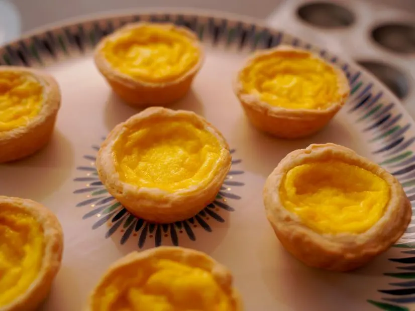 Beauty shot of Molly Yeh's Egg Custard Tarts, as seen on Girl Meets Farm, season 8.
