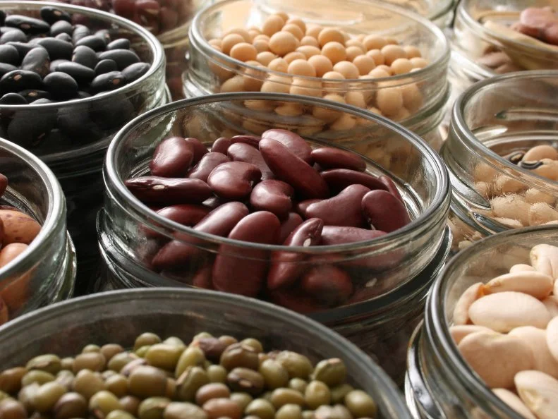 Variety of beans inside jars. Shallow depth of field