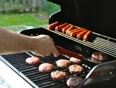 man flipping burgers on Memorial Day
