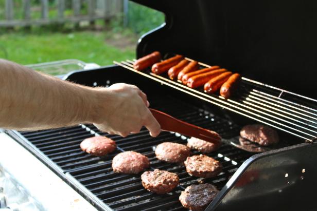 man flipping burgers on Memorial Day