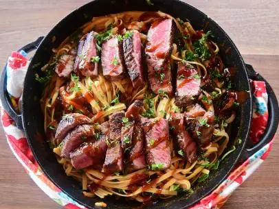 Close-up of Steak and Creamed Greens Pasta, as seen on The Pioneer Woman, season 27.