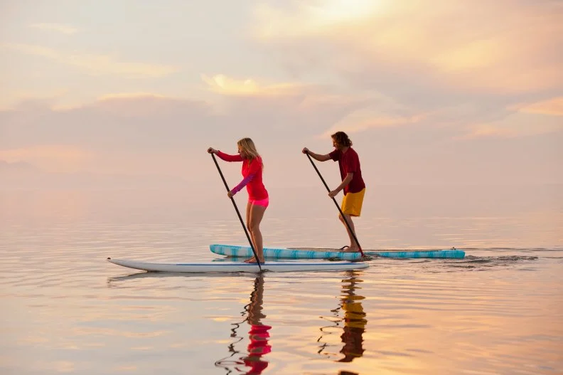 Couple on Standup Paddle Boards in Ocean