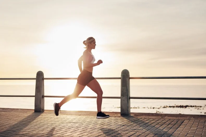 Woman Running on Path By the Ocean