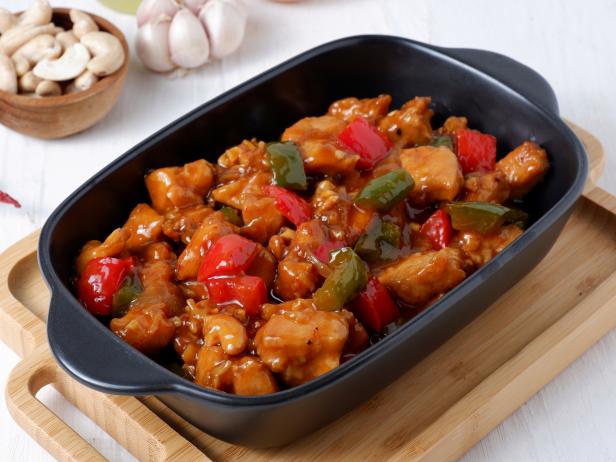 Kung Pao chicken, stir-fried traditional Chinese sichuan dish,with chicken, peanuts, vegetables and chili peppers.