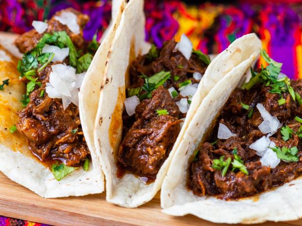 Mexican beef barbacoa. Tacos of beef served with corn tortillas, onions, lime and cilantro.