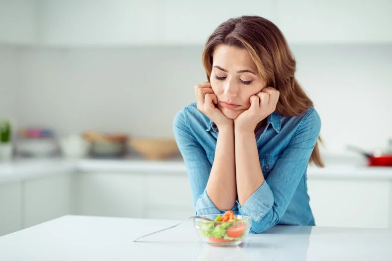 Woman With Salad Looking Sad
