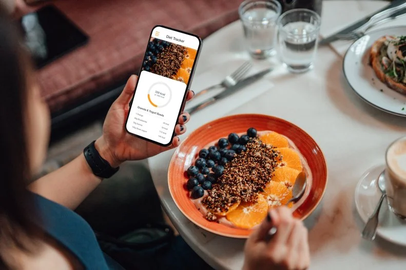 Woman Using Calorie Tracking App on Phone