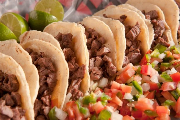 Meat tacos made with fajita meat and pico de gallo in corn tortilla