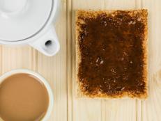 Beef Extract Spread on Toast Against a Light Natural Wooden Background