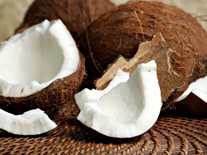 raw coconut meat with whole coconuts