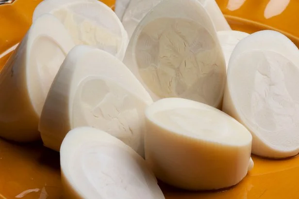 Hearts of palm portion on a yellow dish.