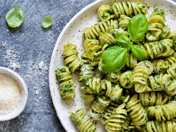 Pasta with pesto and parmesan on a concrete background. View from above.