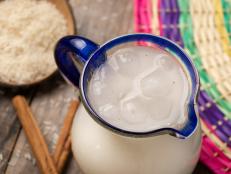Traditional mexican rice horchata with cinnamon on wooden background