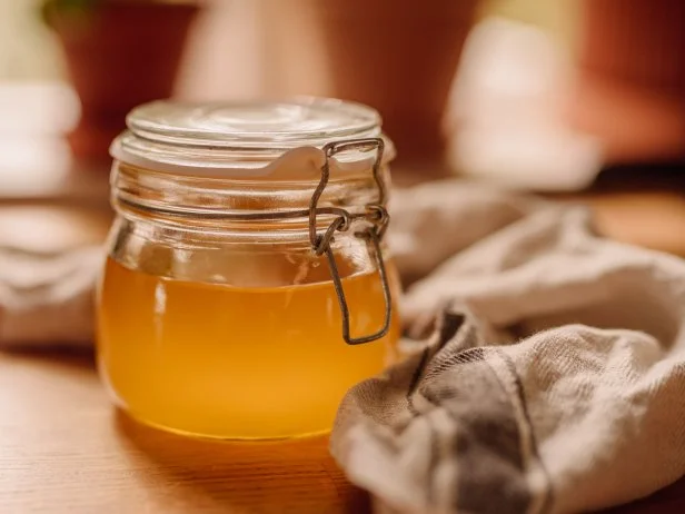 Ghee clarified butter in jarphoto taken indoors in kitchen of full newly homemade ghee