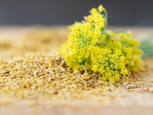 Fennel flower on a small pile of fennel pollen