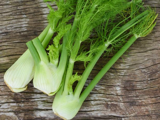 Fennel vegetable from the garden , Fresh raw fennel bulbs ready to cook on food wooden kitchen background