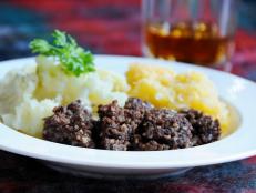 Scottish meal of Haggis, neeps and tatties - and of course a wee dram. Narrow depth of field on haggis. Traditional meal for Rabbie Burns night.