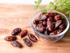 Juicy dates on a old wooden table