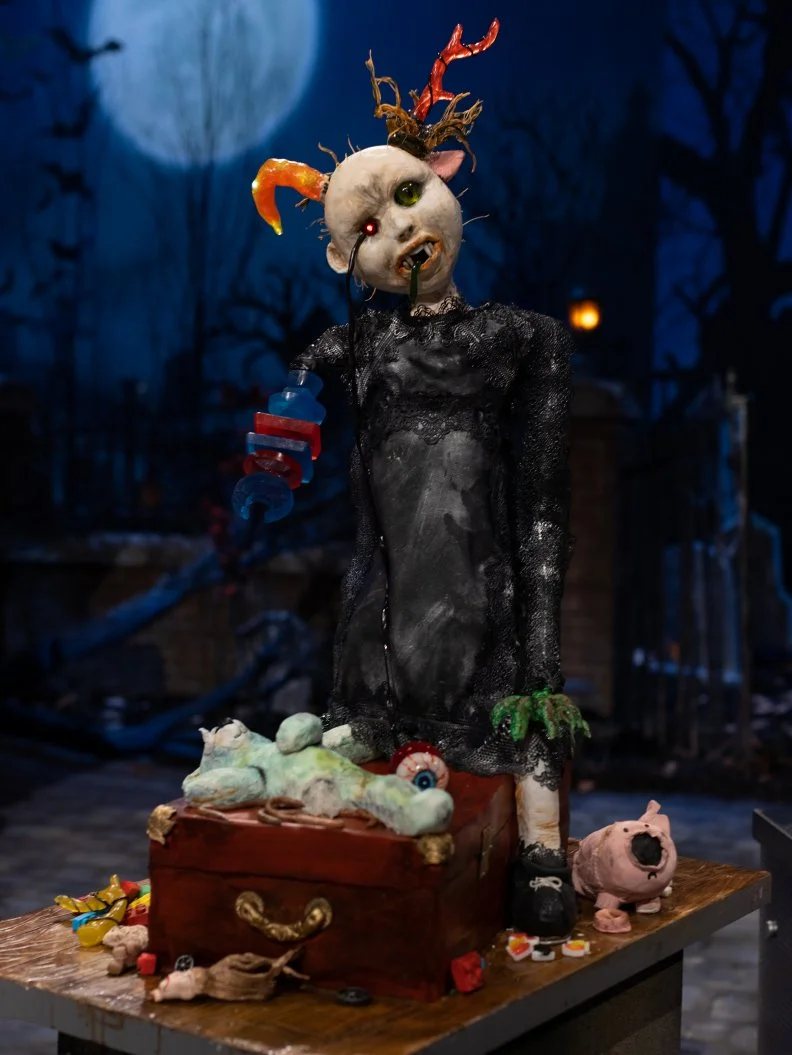 Contestants Lilian Halabi, Jewel Burgess and Kim Simons round one cake, "BELLE, THE POSSESSED TOY", as seen on Halloween Wars, Season 11.
