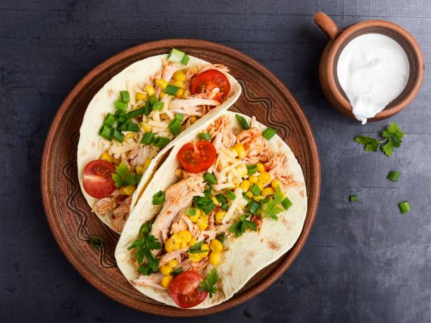 Homemade slow cooker chicken taco with corn on rustic  plate viewed from above