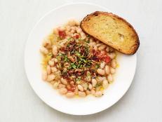 Beans shouldn&rsquo;t just be relegated to a side dish. Let them be the star of a hearty but light meal full of flavor by slowly cooking dry beans with tons of aromatics. You may have extra bean liquid left over, as you need a generous amount to cook the beans properly. Simply use it in place of vegetable stock in another recipe or add to your next pot of beans.