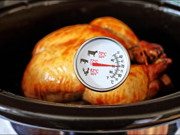 Chicken in a roster with a temperature gage inserted.