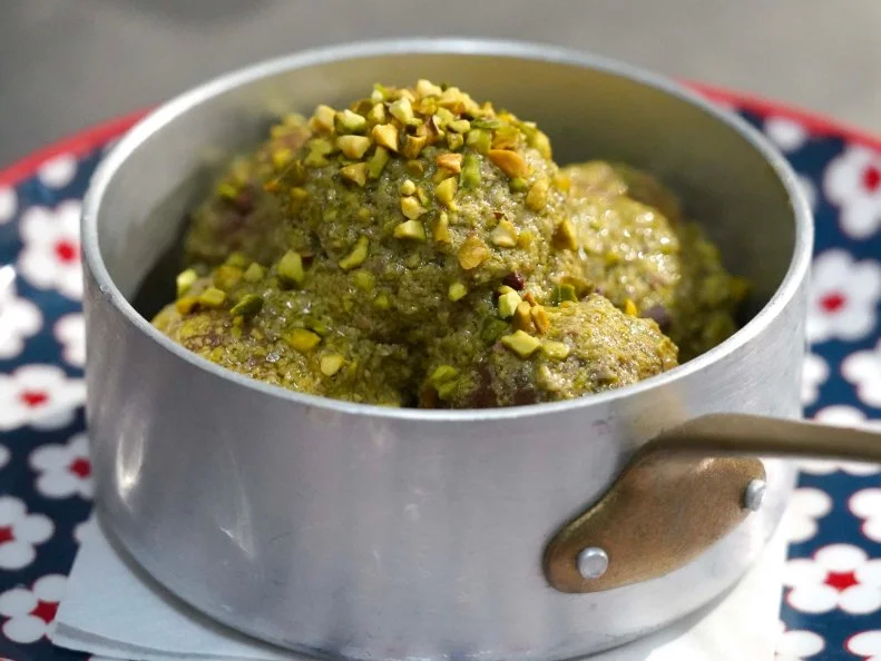 A close up of the pistachio and mortadella meatballs, made by chef Francesco Cionci and Giada De Laurentiis, as seen on Bobby & Giada In Italy, Season 1.