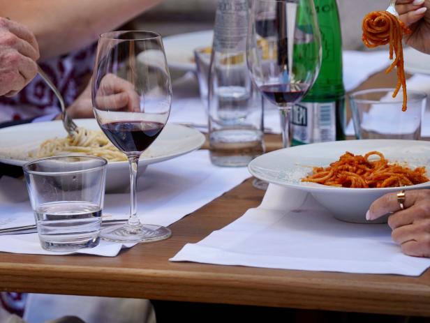 A close up of two of the pastas, cacio e pepe and amatriciana, ordered by Bobby Flay, Giada De Laurentiis, and their two friends, as seen on Bobby & Giada In Italy, Season 1.