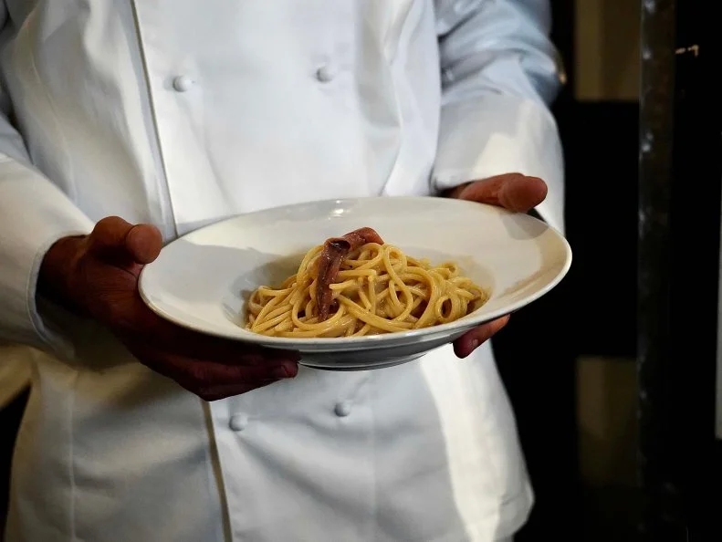 Chef Nabil Hassen shows off his butter and anchoby pasta, as seen on Bobby & Giada in Italy, Season 1.