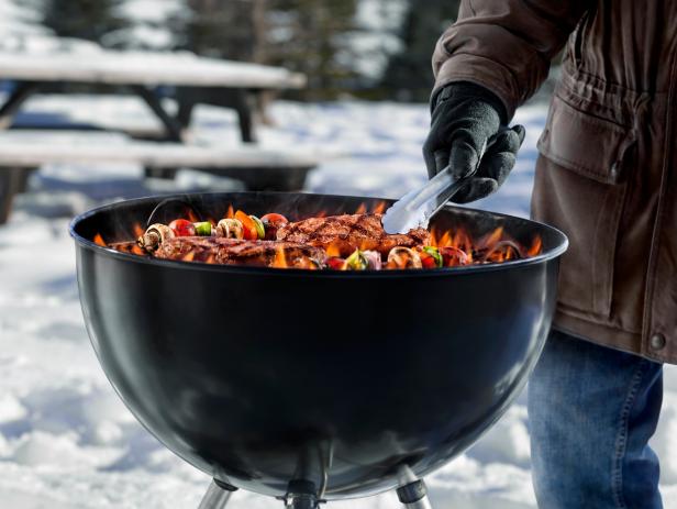 Cooking Steaks and Kabobs on a Backyard BBQ in the Middle of Winter