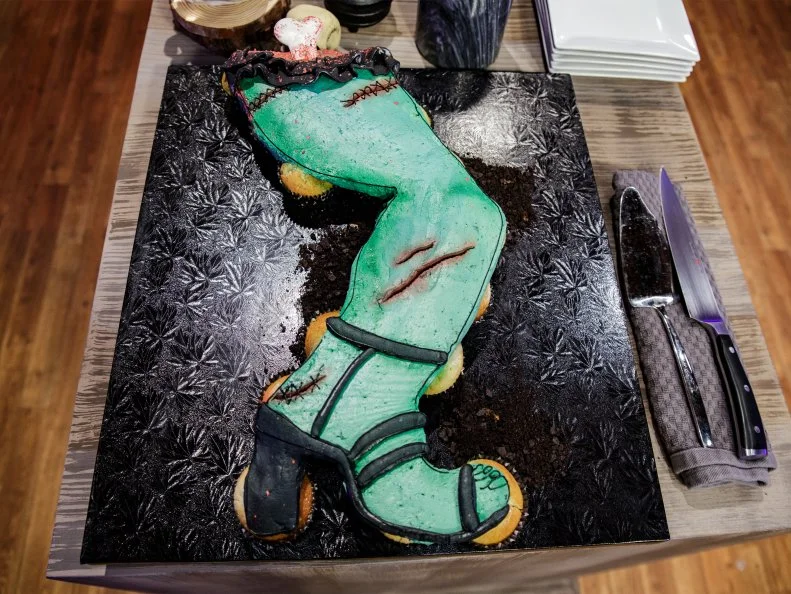 Megan Baker's pull apart cupcake leg made of Lemon Basil cupcake with strawberry vanilla bean cheesecake filling and a basil swiss buttercream, as seen on Halloween Baking Championship, Season 7.