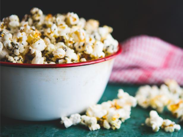 Homemade popcorn filled with spices and grains. Perfect snack for movie days at home.