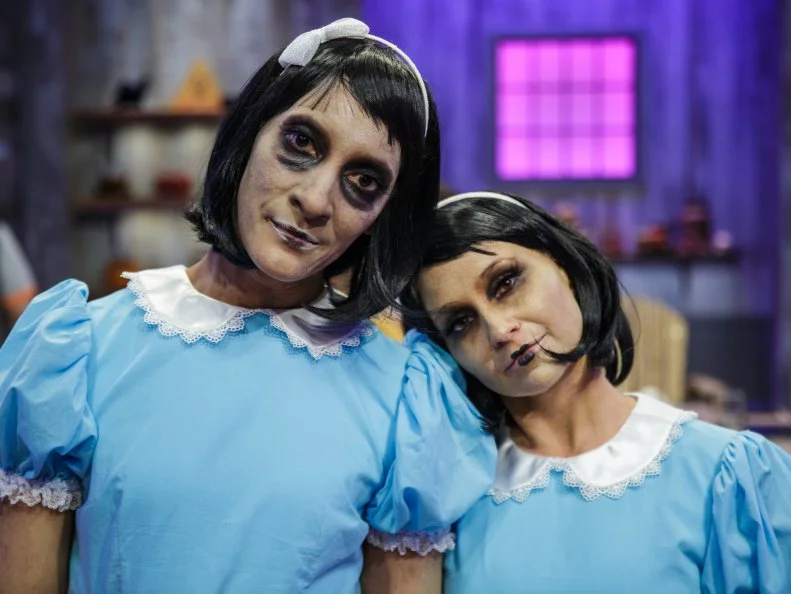 Judges Carla Hall and Stephanie Boswell pose in their costumes, as seen on Halloween Baking Championship, Season 7.