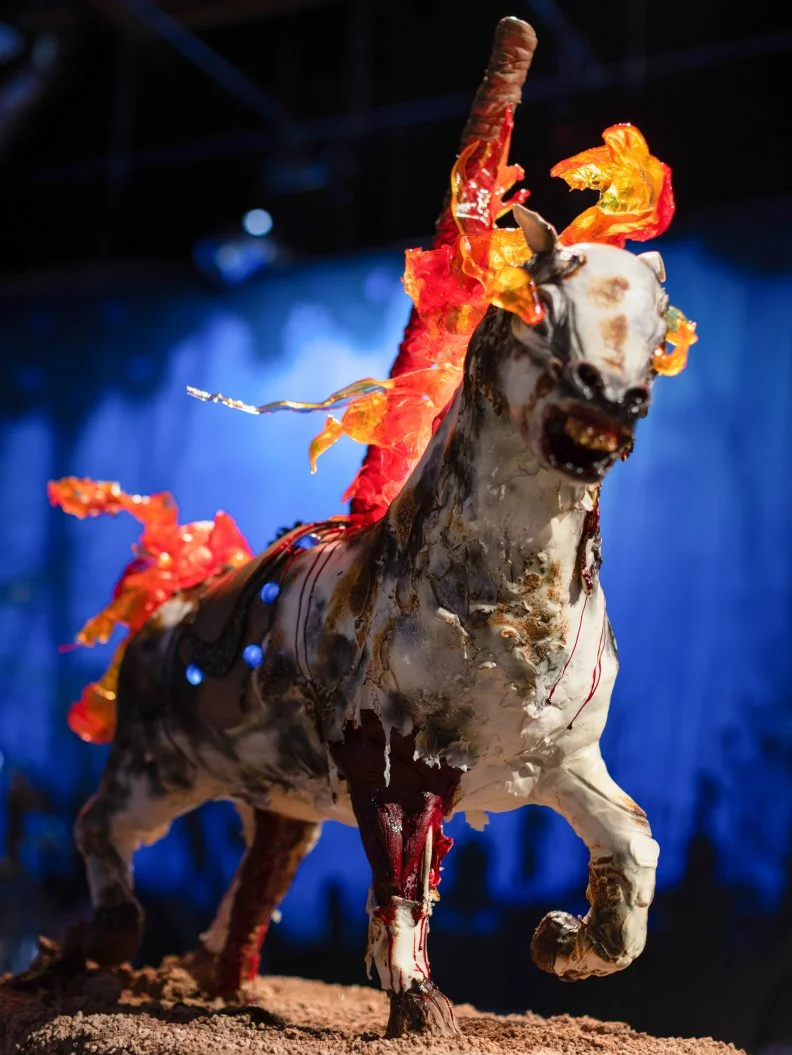 Team Pumpkin to Talk About’s completed fiery carousel cake, as seen on Halloween Wars, Season 11.