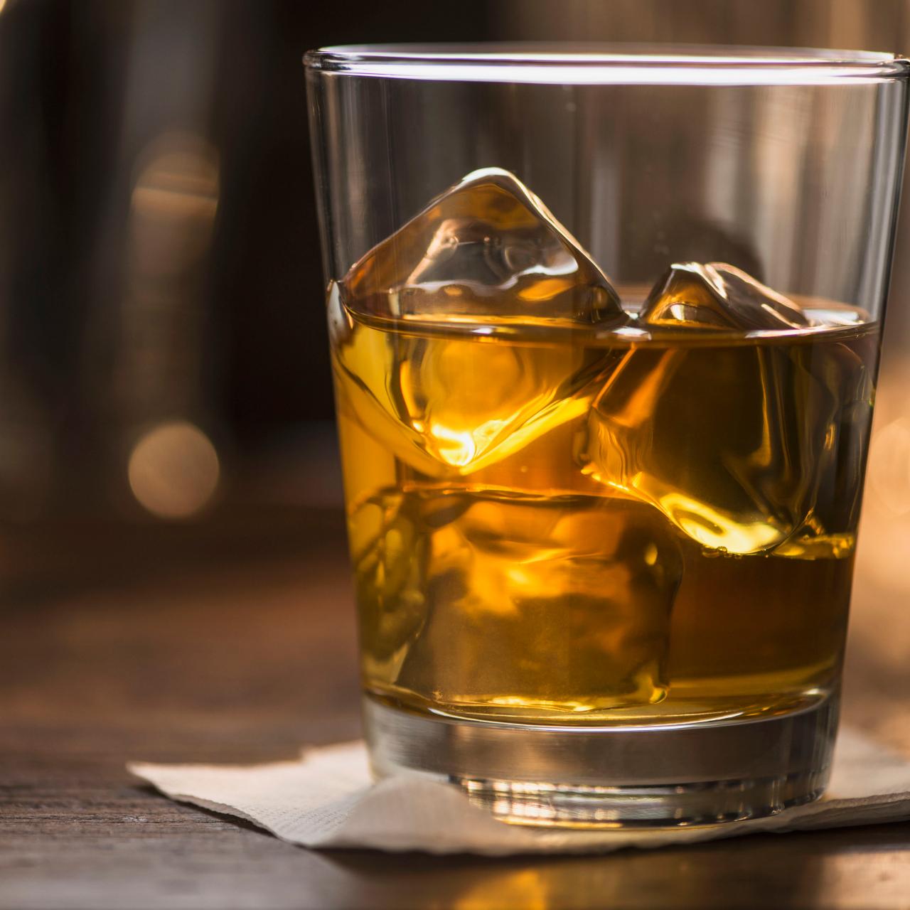 https://food.fnr.sndimg.com/content/dam/images/food/fullset/2021/10/13/bourbon-on-the-rocks-wood-bar-glass-napkin.jpg.rend.hgtvcom.1280.1280.suffix/1634149221620.jpeg