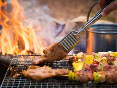 Close up grilling barbecue in the campground at summer camp travel, Skewers of pork and beef fillet on barbecue party in camping, Summer Camp Travel one activity for relaxing.