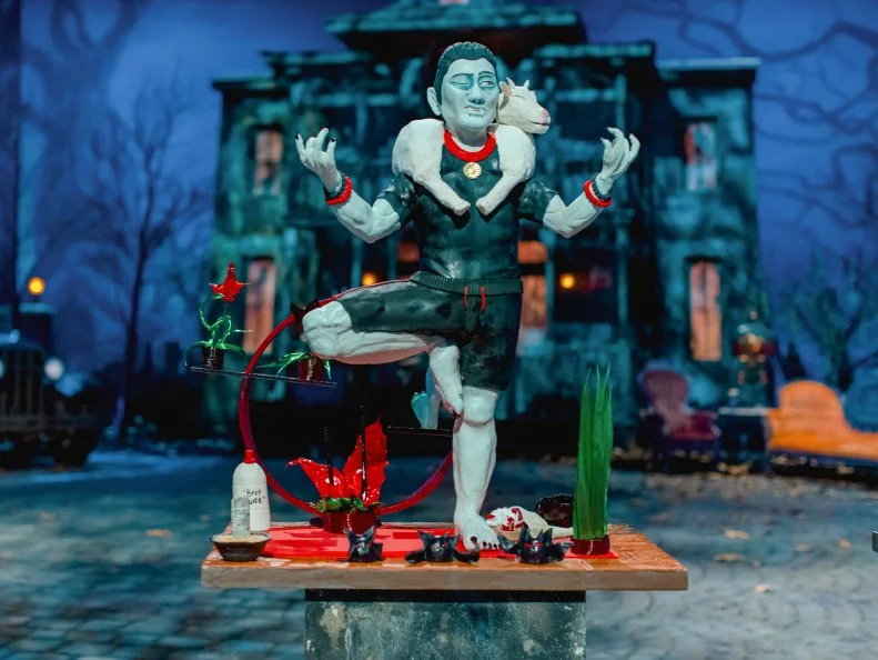 Team Mischievous Monsters create a cake of Dracula in a yoga pose during a goat yoga class, as seen on Halloween Wars, Season 11.