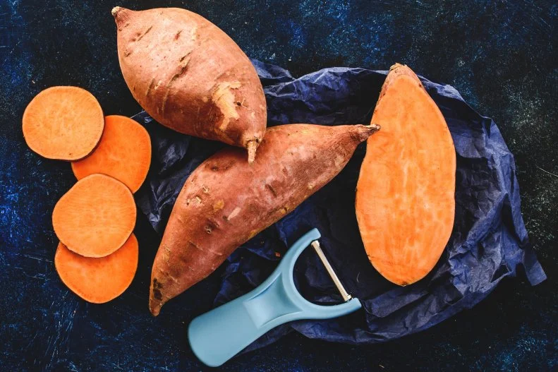 Sliced and whole sweet potatoes