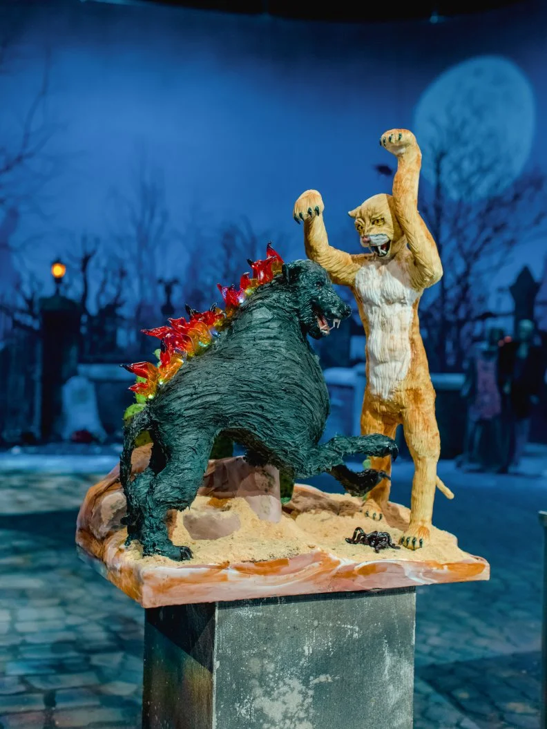 Team Ghosts With The Most’s finished Dueling Monster cake, a hound battles a werecougar, as seen on Halloween Wars, Season 11.