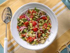 Lima beans are almost always on the menu when you visit a traditional Gullah or Low Country soul food restaurant. They've usually been slow-cooked for hours with a smoked turkey leg or ham hock. To be honest, I'm not a huge fan of that way of cooking them, so this salad is my favorite way to serve lima beans. I love the tangy vinaigrette and the colorful crunchy vegetables added to the beans. This is another one of those recipes that gets better the longer it sits in the fridge.