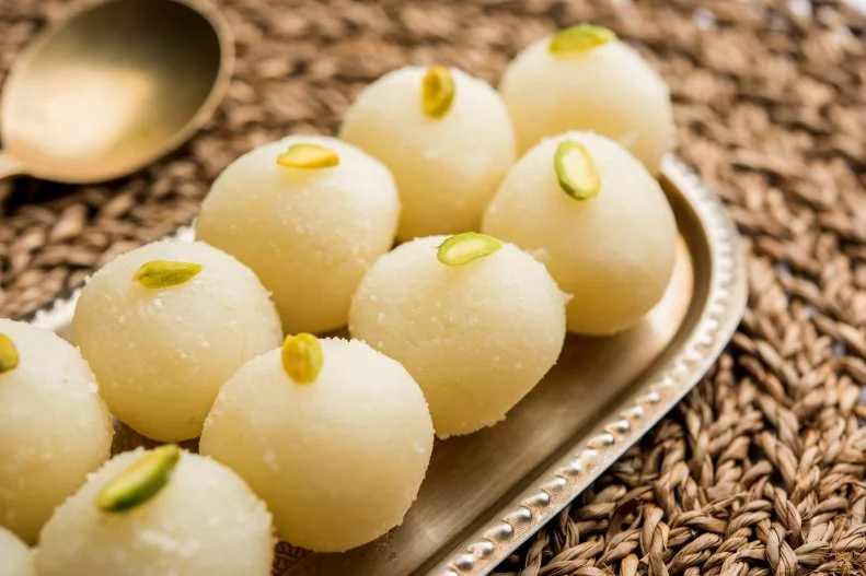Indian Rasgulla or dry Rosogulla dessert/sweet served in a bowl. selective focus