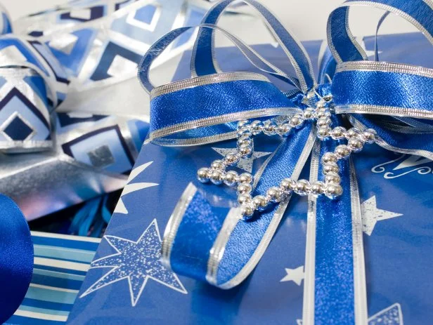 Silver Star of David on a blue wrapped Hanukkah gift