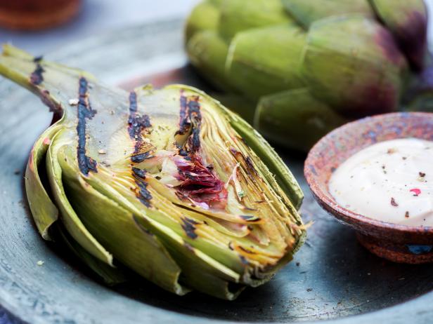 Grilled artichoke with a side of balsamic mayonnaise dipping sauce.