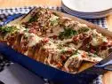Description: Food Network Kitchen's Hot Brown-Stuffed French Toast. Keywords: Eggs, Half-and-Half, Pecorino, Nutmeg, White Bread, White Cheddar, Roma Tomatoes, Cracked Pepper Turkey, Bacon, Milk, Parsley, Paprika.