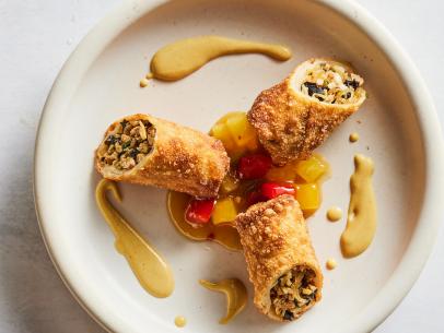 Description: Ming Tsai's Tsai Family Egg Rolls with Sweet and Sour Sauce and Spicy Mustard. Keywords: Garlic, Ginger, Serrano Chiles, Ground Pork, Chinese Cabbage, Bamboo Shoots, Soy Sauce, Black Mushrooms, Shoaxing Wine, Scallions, Pineapple, Mango, Dry Mustard, Dijon Mustard.