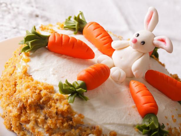 Celebratory cake decorated with carrot and bunny close-up on the table. horizontal
